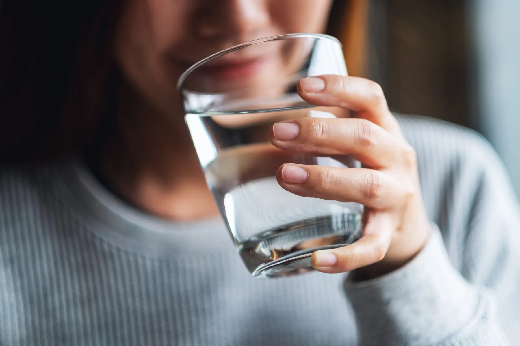 Close-up of a person holding a full glass